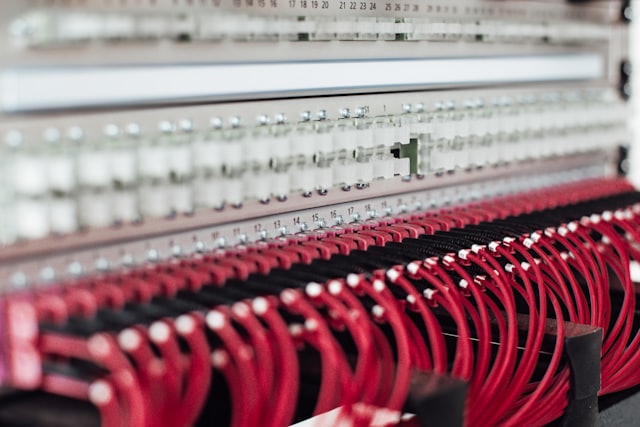 Patch panel dense with red cables