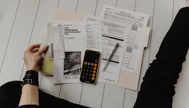 Tax documents and calculator on a desk