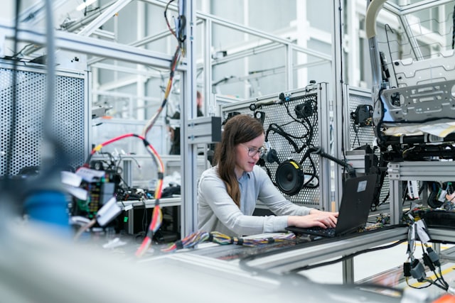 Engineer with laptop on a factory floor