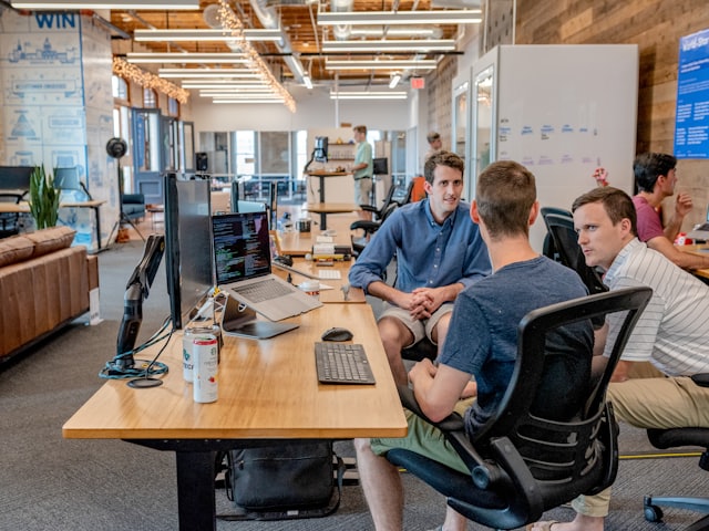 Sales team talking at office desks